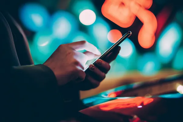 A glamorous woman holding casino chips in a neon-lit environment, representing the premium online casino atmosphere of ZBZBET.